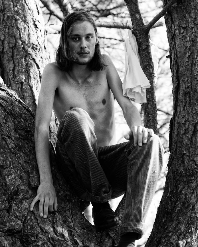 Black-and-white portrait in a tree